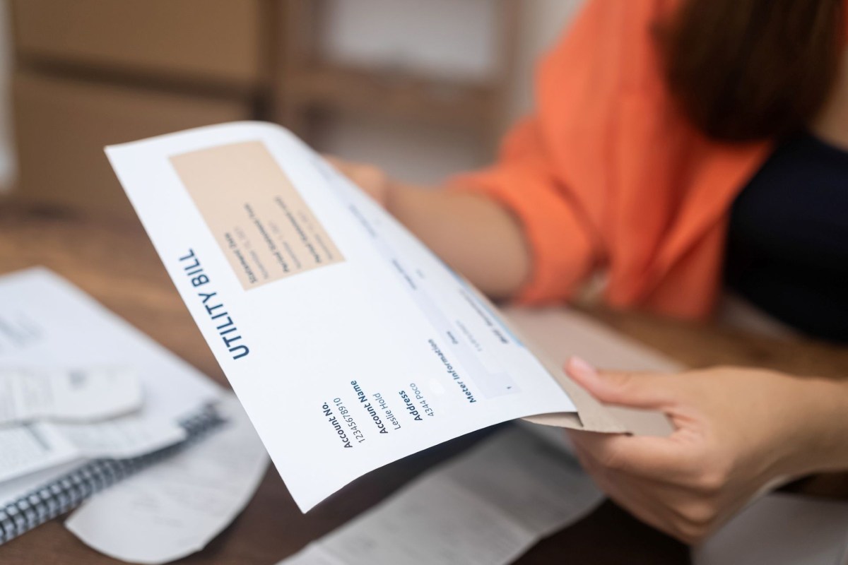 A person examines a utility bill.