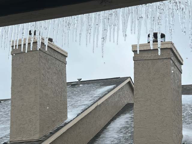 Icicles hanging from a roofline.