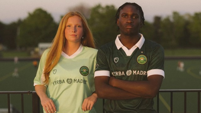 A male and female soccer player pose confidently in team jerseys, with a green field in the background.