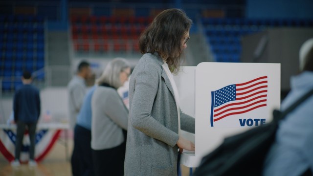 A woman at a voting booth.