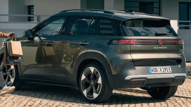A person carrying shopping bags to a Volkswagen ID. Cross.