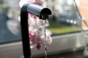 Water running out of a faucet.