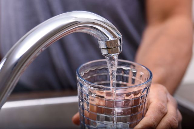 Filling a glass with water.