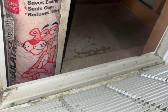A pink insulation bag is partially visible near a dirty vent return cover and floor.