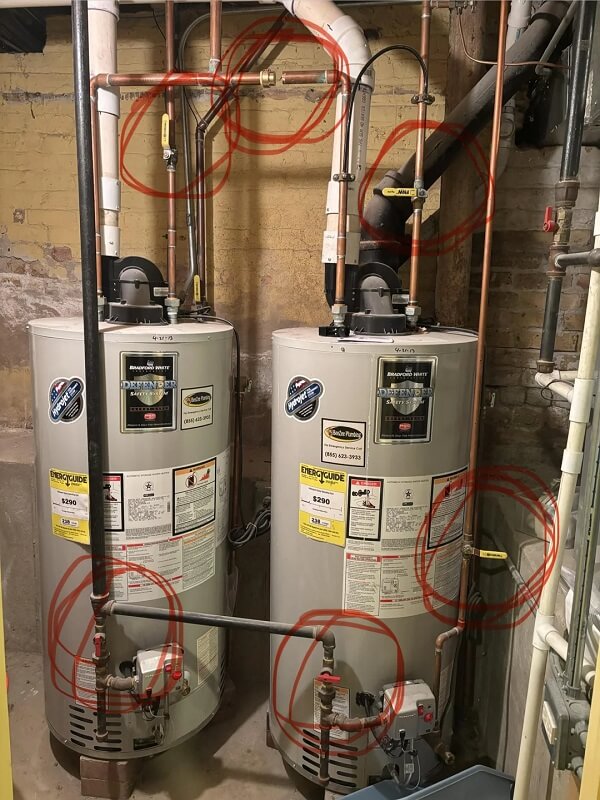 Two water heaters next to each other.
