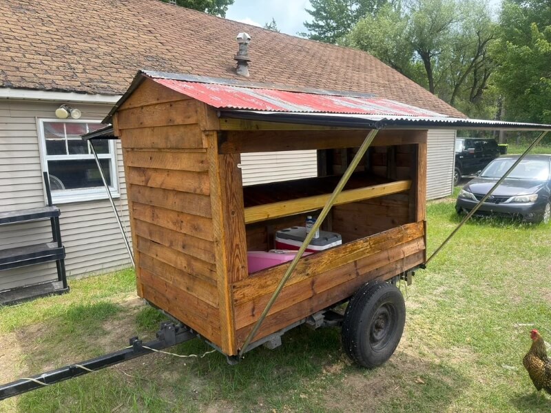 A mobile farmstand in a yard.
