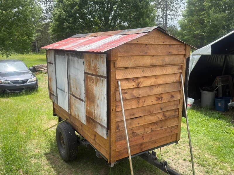 A mobile farmstand in a yard.