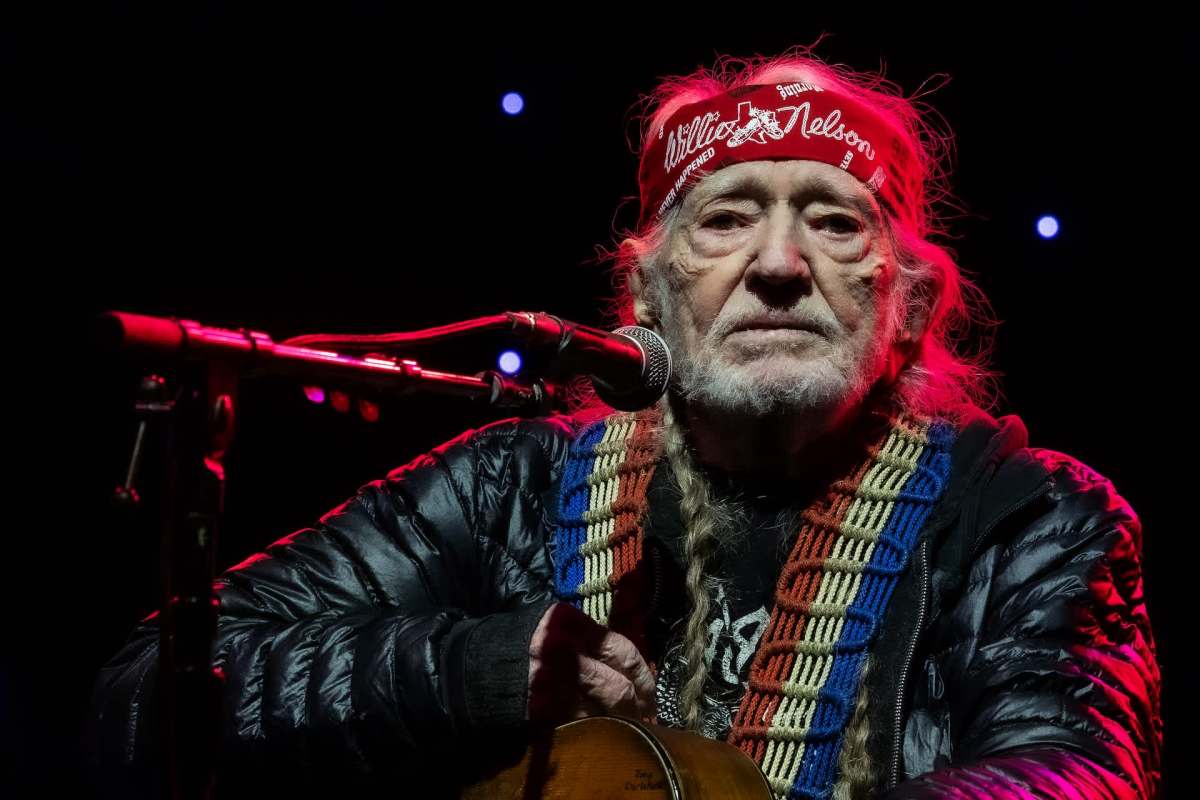 Willie Nelson with a guitar.