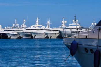 A row of luxury yachts docked in a marina.