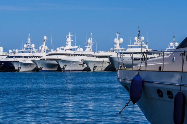 A row of luxury yachts docked in a marina.