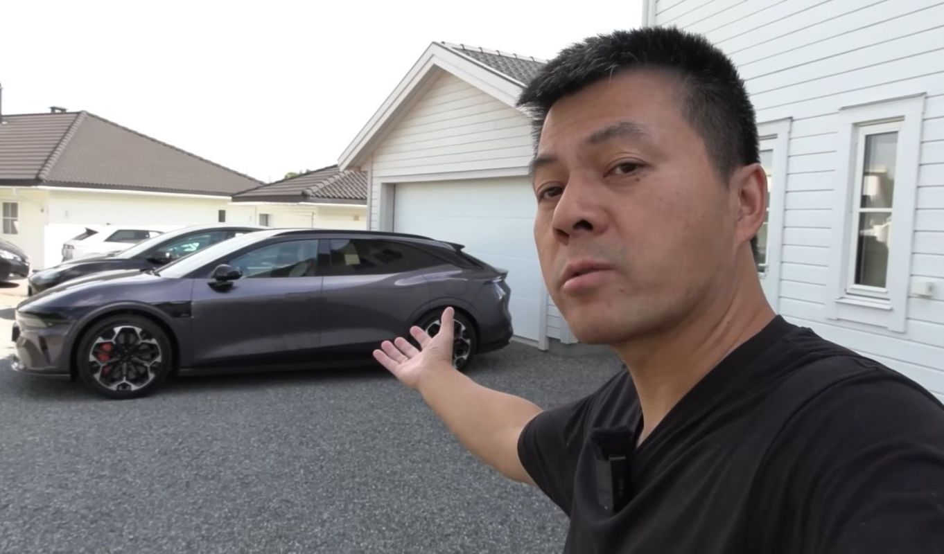 A person gesturing to a Zeekr 7GT EV.