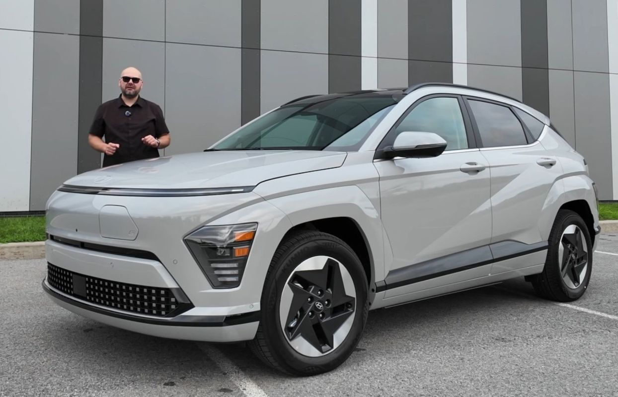 A person standing with a 2026 Hyundai Kona EV.