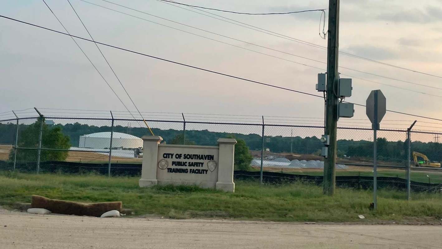 Sign for the City of Southaven Public Safety Training Facility with a fenced area and construction equipment in the background.