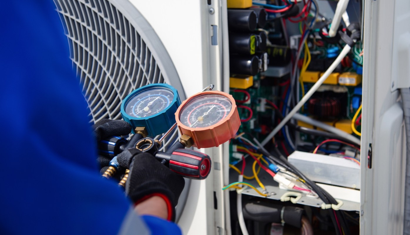 A technician working on an AC unit.