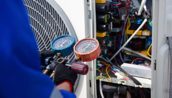 A technician working on an AC unit.
