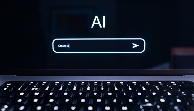 A laptop screen displays the text "AI" and a prompt field labeled "Create a."
