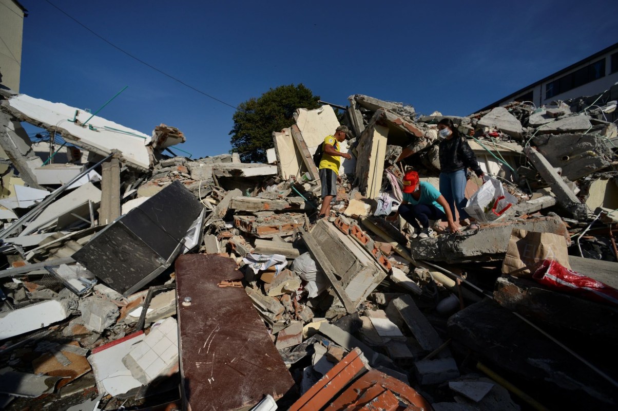 People searching through rubble.