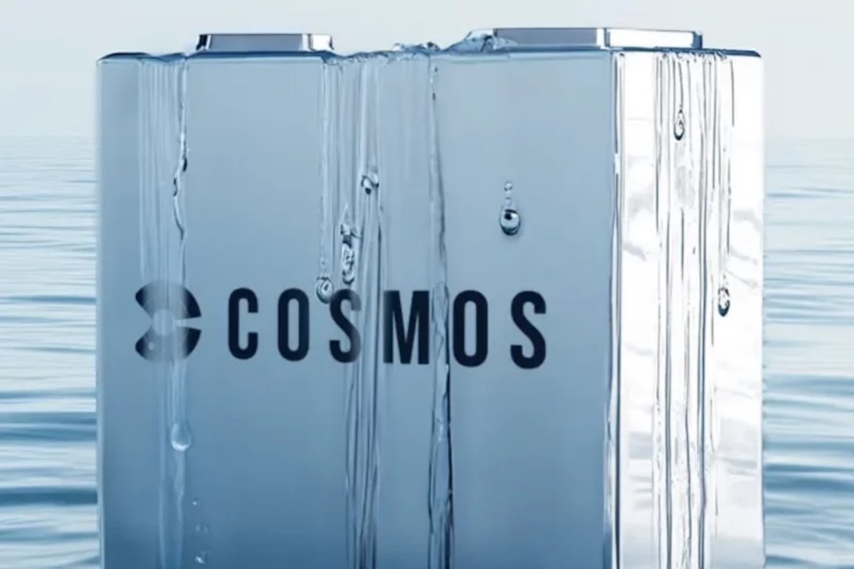 A metallic object with the logo "COSMOS" is surrounded by water droplets.