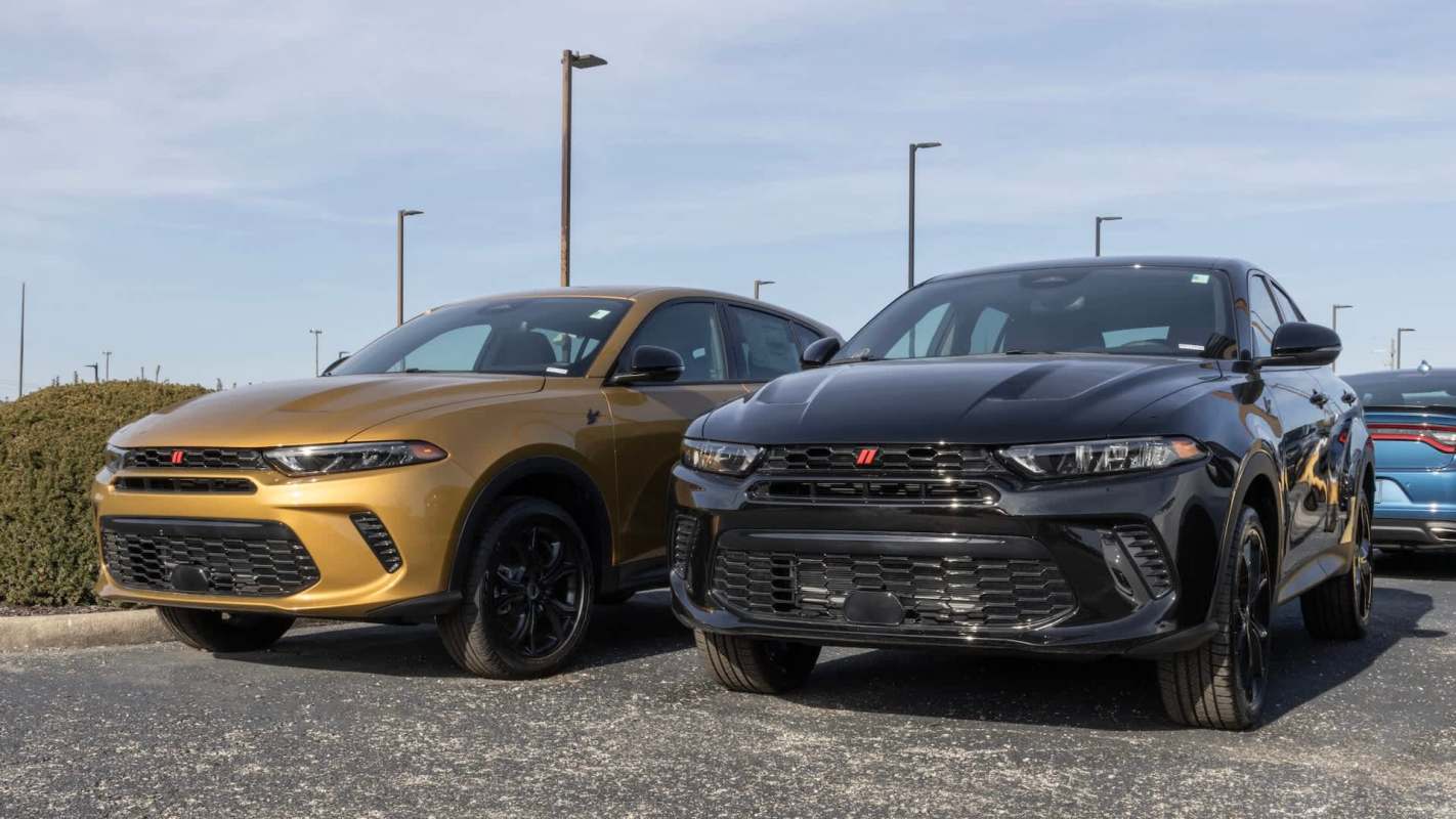Two Dodge Hornet SUVs, one gold and one black, parked next to each other.
