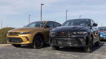 Two Dodge Hornet SUVs, one gold and one black, parked next to each other.