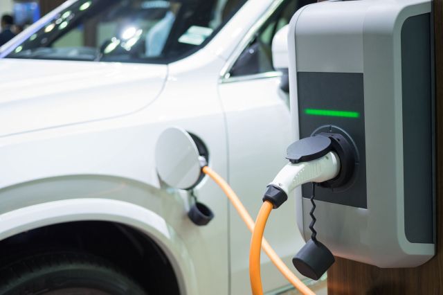 An electric vehicle is plugged in and charging