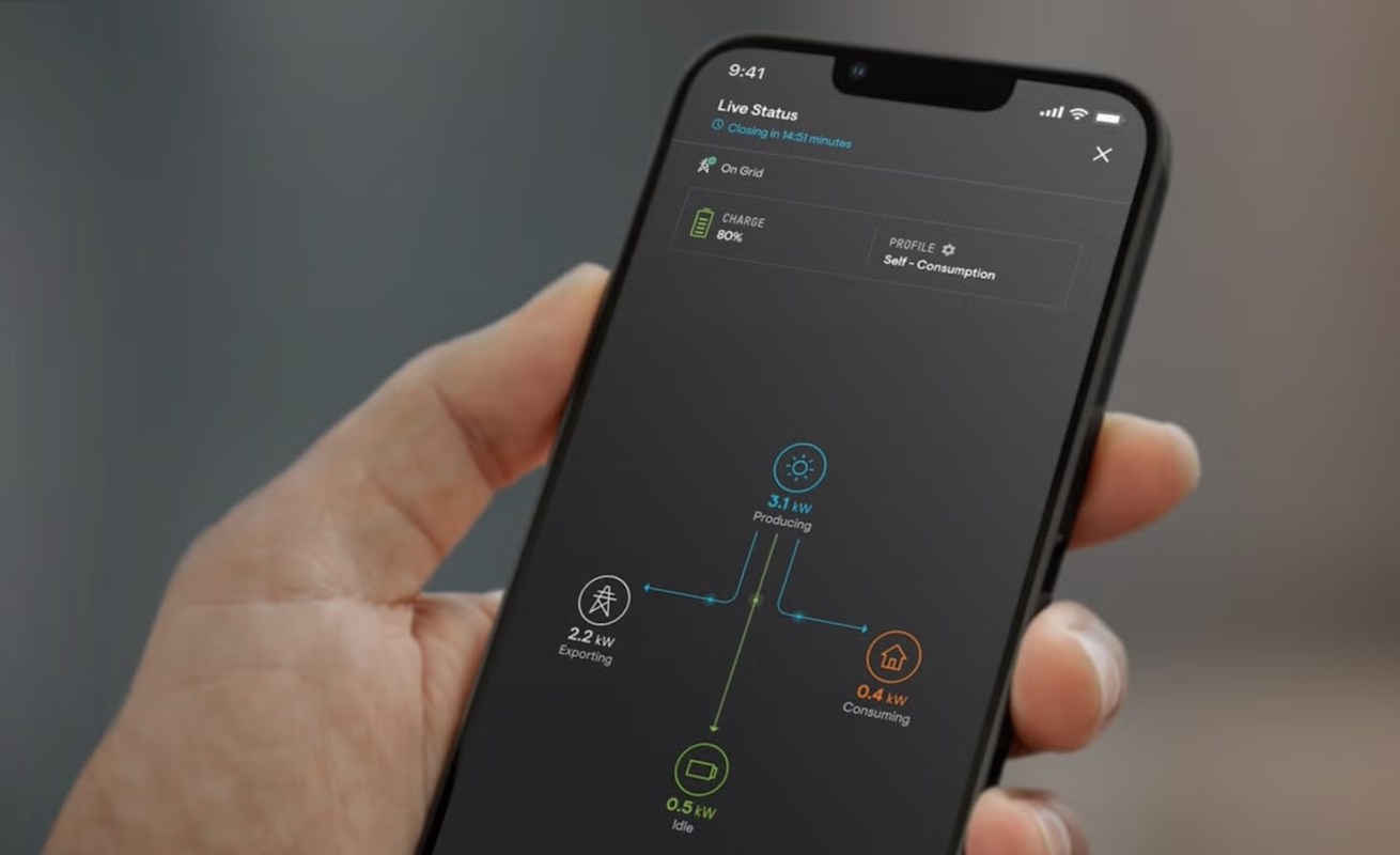 A smartphone displaying live energy production and consumption statistics.