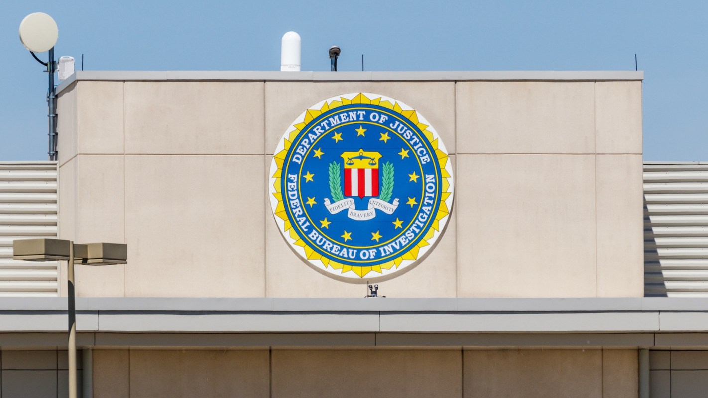The seal of the Federal Bureau of Investigation displayed on a building facade.