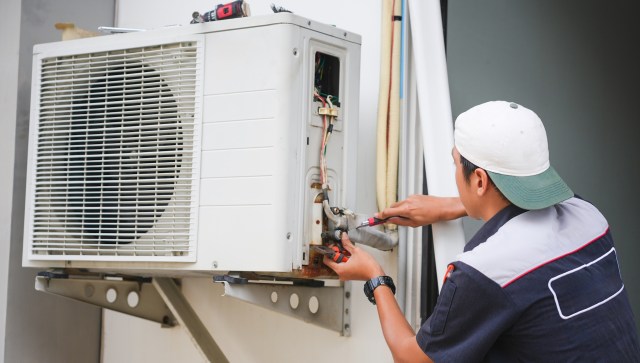 A technician repairing an HVAC unit.