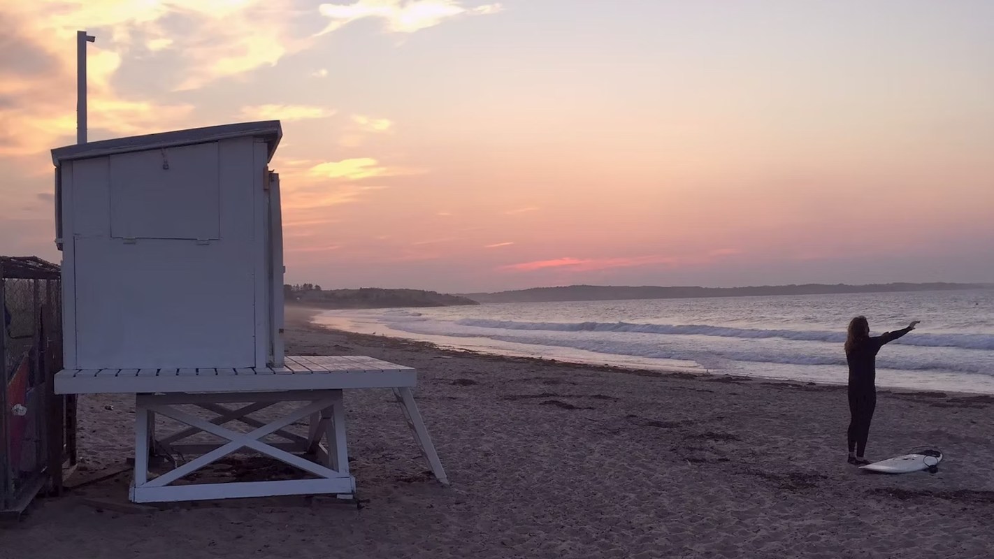 A lifeguard tower on a beach at sunset.