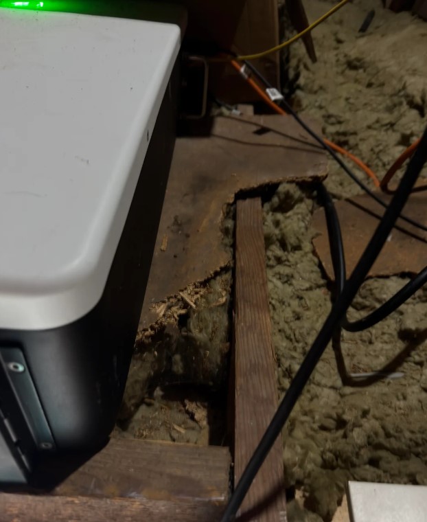 Rotting wood visible underneath the battery.