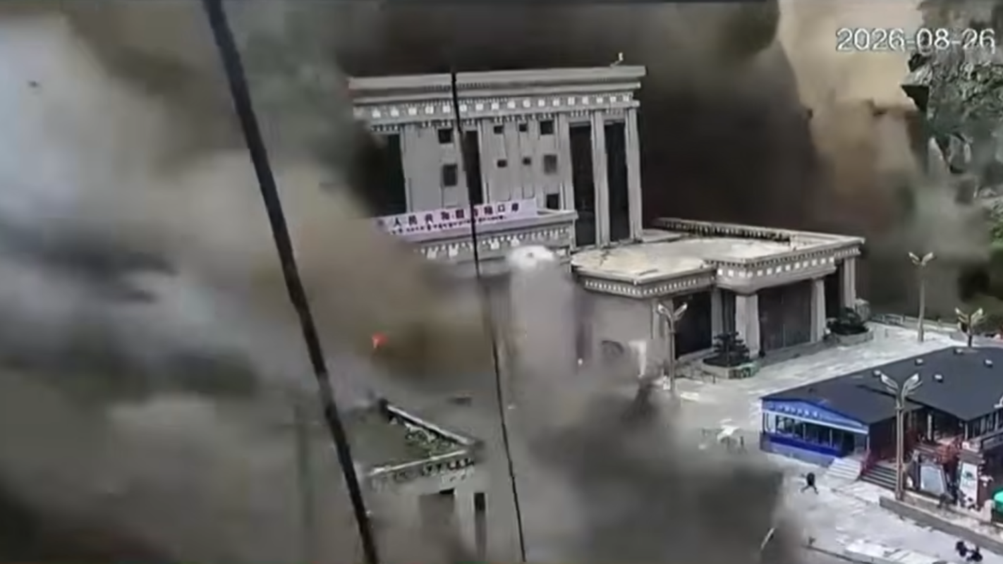 Flash flooding from a mudslide overtakes a building.
