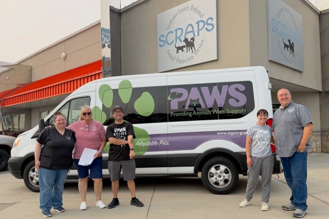 People in front of an animal rescue van.