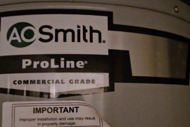 A label on a water heater featuring the A. O. Smith logo and "ProLine Commercial Grade."