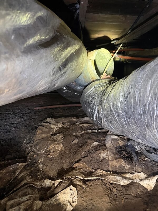 Flex ducting in a crawl space.