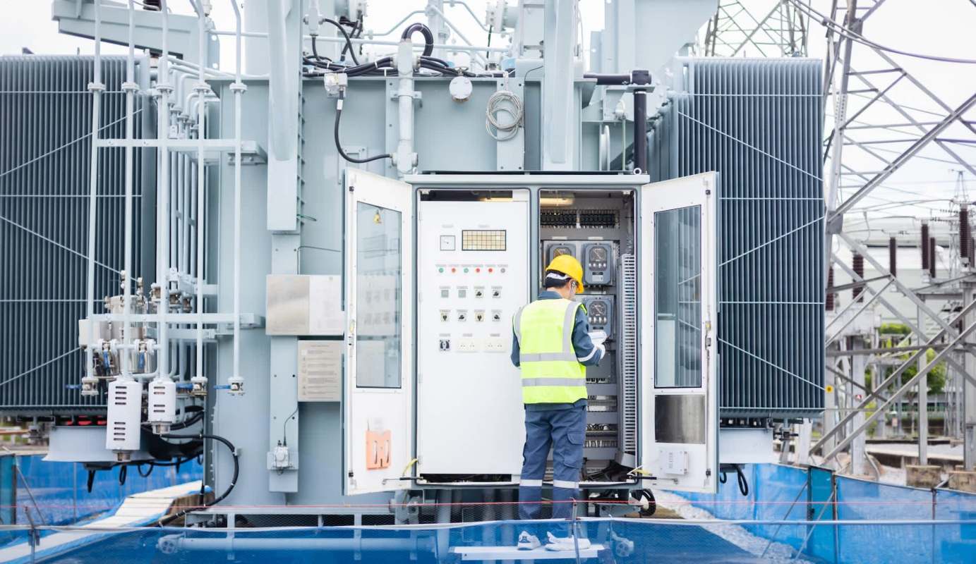 A worker inspecting an electrical substation.