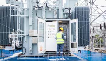 A worker inspecting an electrical substation.
