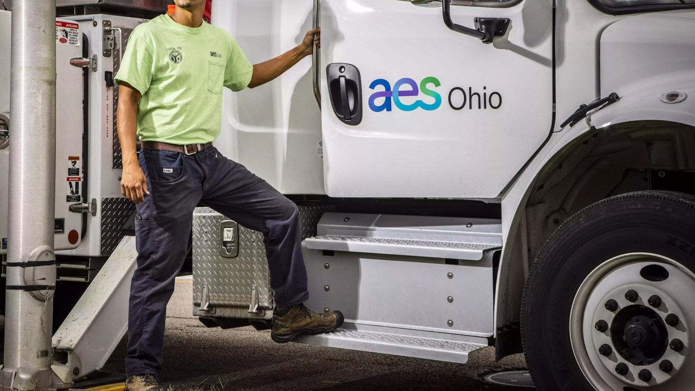 A worker standing by an AES Ohio truck.