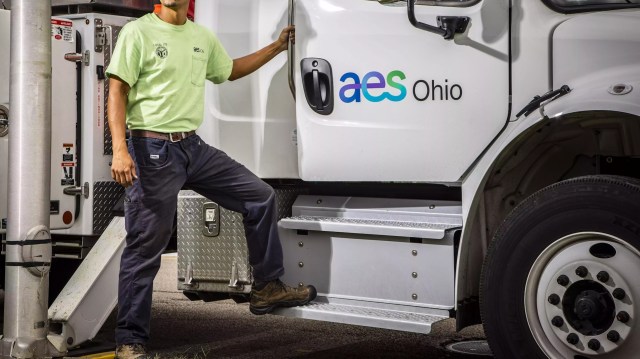 A worker standing by an AES Ohio truck.