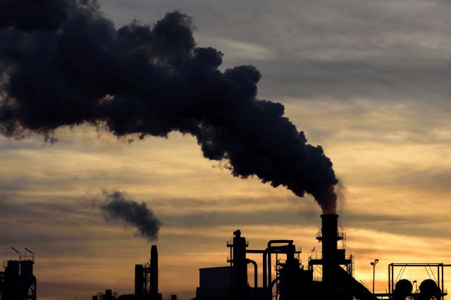 Smoke billowing out of a factory.