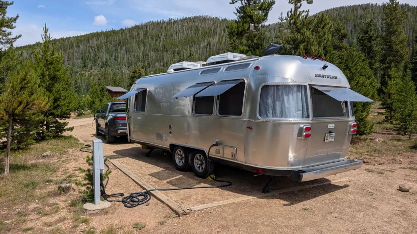An Airstream being towed by a Rivian.