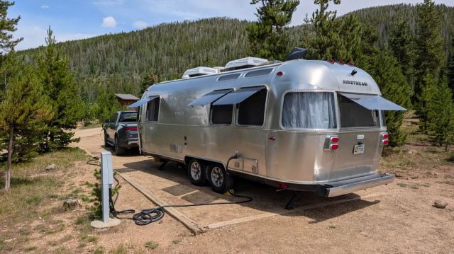 An Airstream being towed by a Rivian.