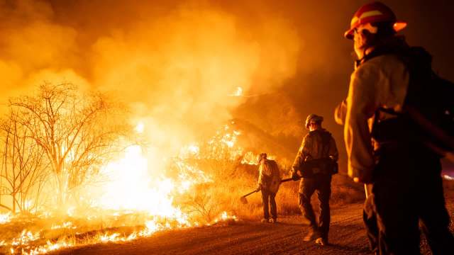 Firefighters combating a wildfire.