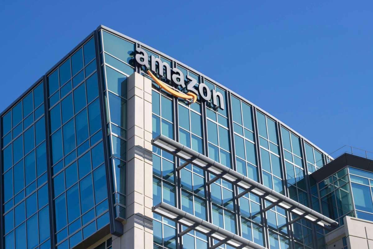 A building with glass windows and an Amazon logo on the exterior.