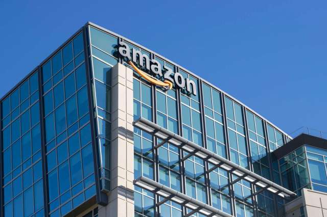 A building with glass windows and an Amazon logo on the exterior.