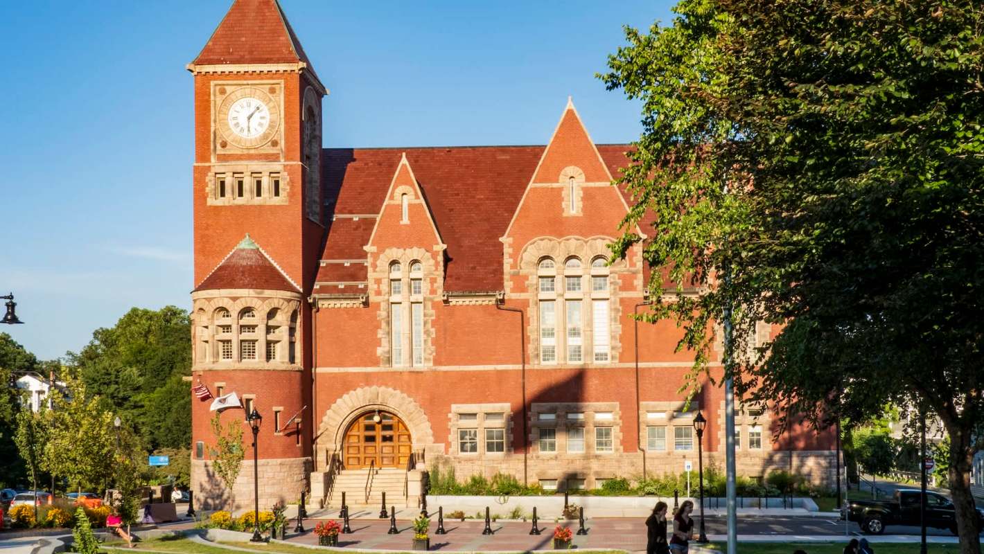 Amherst Town Hall in Massachusetts, with a clock tower and landscaped surroundings.