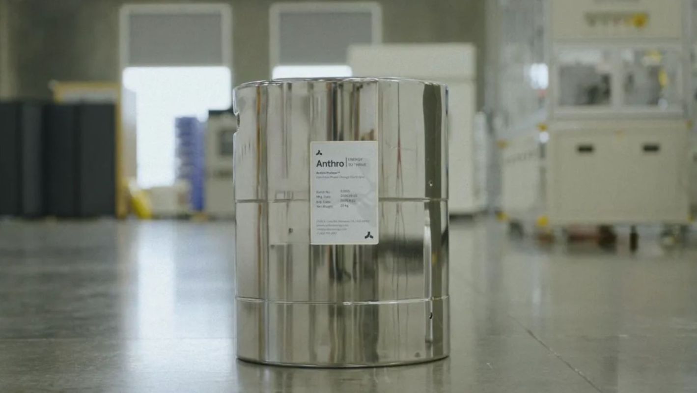 A metallic container labeled "Anthro" placed on a polished floor in an industrial setting.