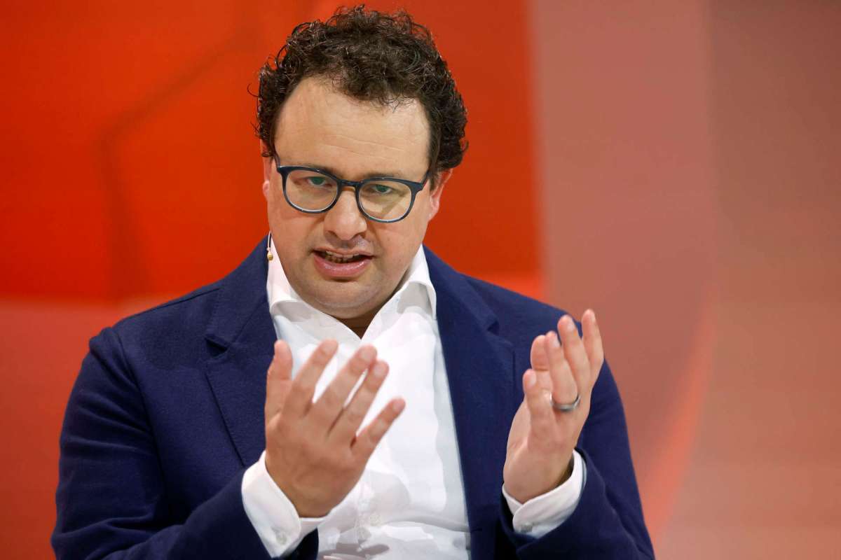 Anthropic CEO Dario Amodei gestures while speaking on stage at an event.