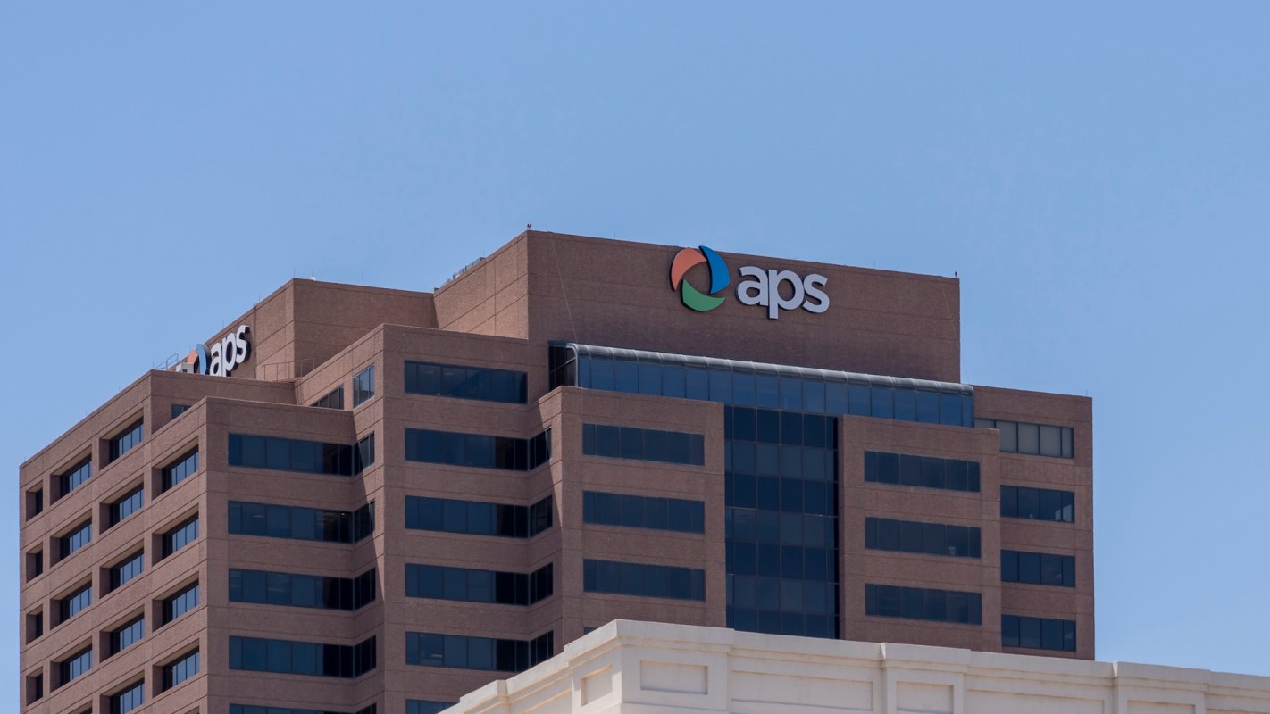 A building with the 'aps' logo on its roof and large windows.