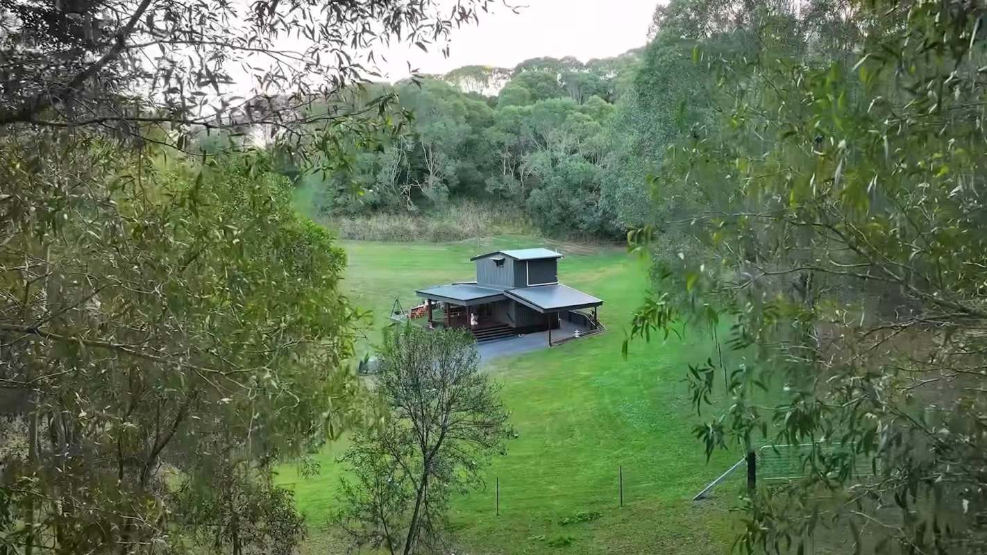 A cabin in a forest clearing.
