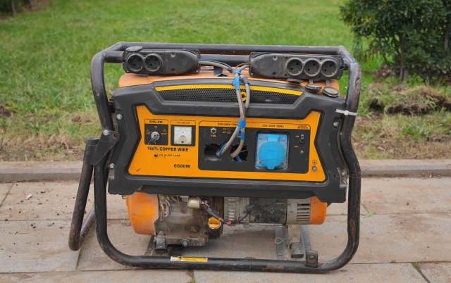 A portable generator with various outlets and controls on the front.